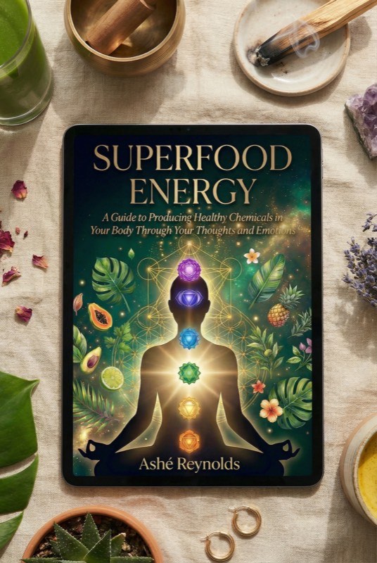 ‘Superfood Energy’ by Ashé Reynolds displayed on a tablet among crystals, palo santo and tropical leaves.