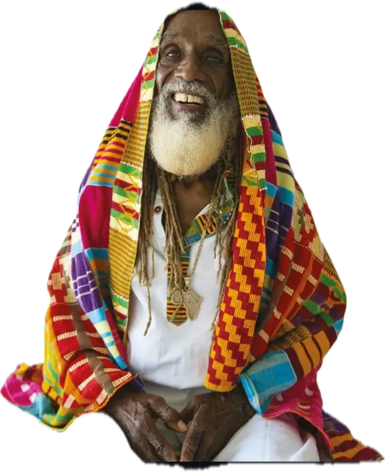 Dr. Aris LaTham smiling, wrapped in a bright kente cloth over a white shirt, with a white beard and long locs.