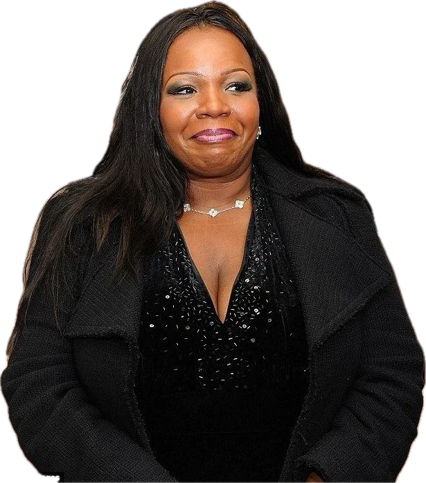 Cynthia P. Stafford smiling, with long dark hair, in a black sequinned top and black coat with a delicate floral necklace.